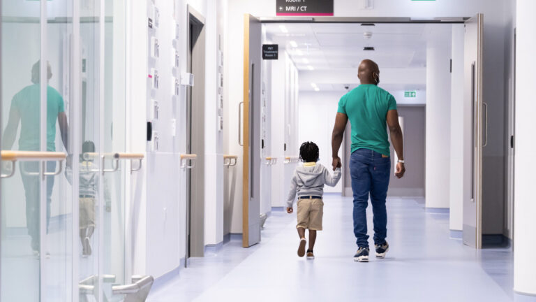 parent and child walking to proton therapy treatment