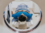 Patient receiving a CT scan before proton beam therapy to plan precise cancer treatment