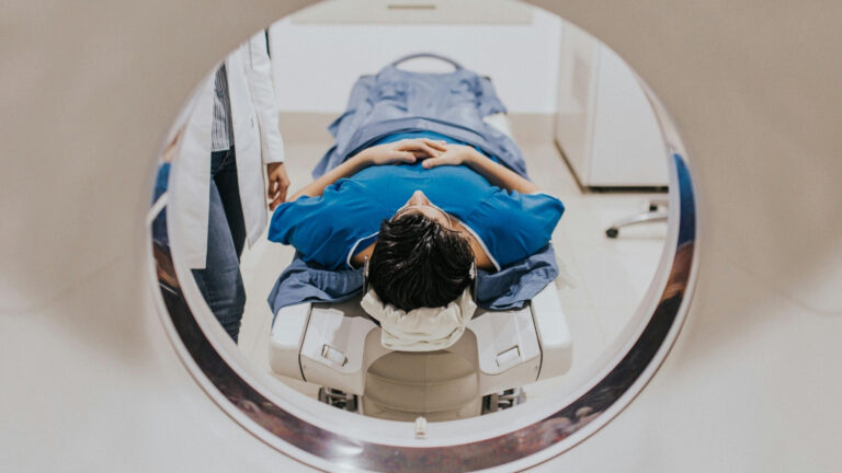 Patient receiving a CT scan before proton beam therapy to plan precise cancer treatment