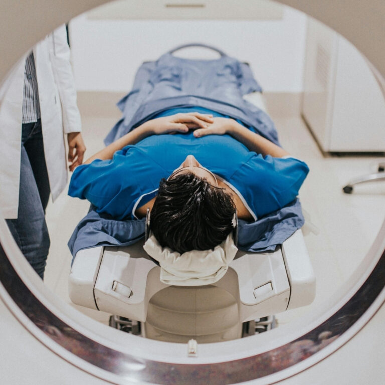 Patient receiving a CT scan before proton beam therapy to plan precise cancer treatment
