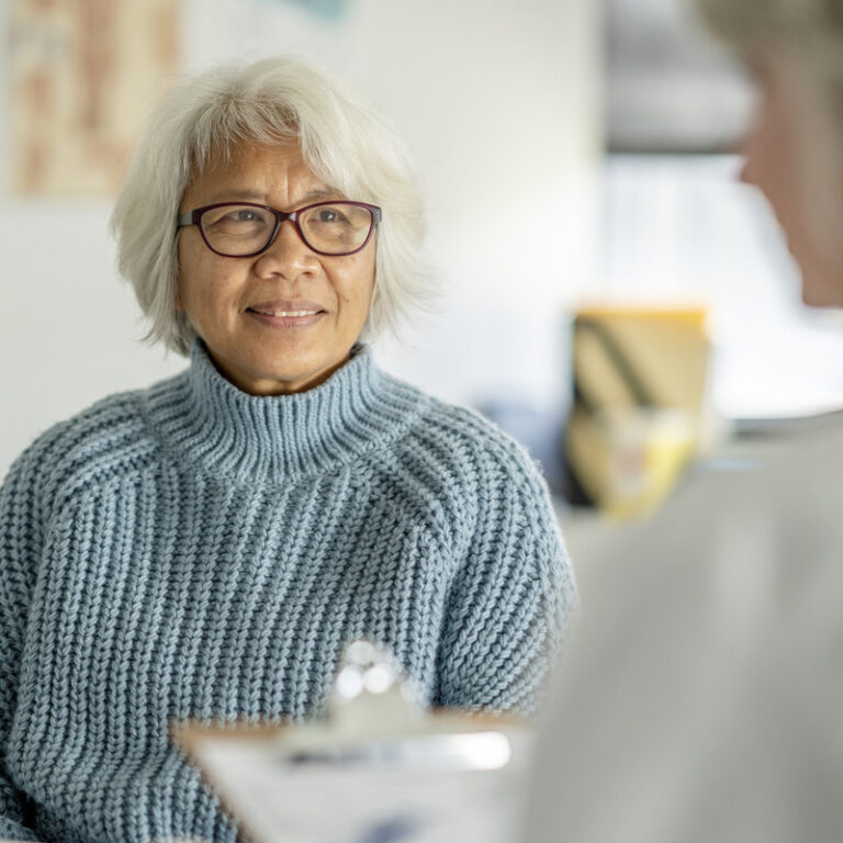 Oncologist talking through cancer treatment options with patient